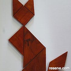 Create a classic wooden tangram puzzle of a cat
