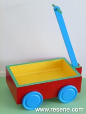 Paint a wooden cart with bright colours