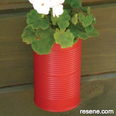 Create tin can plant pots to hang on your fence