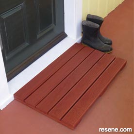 An all-weather doormat using grooved decking