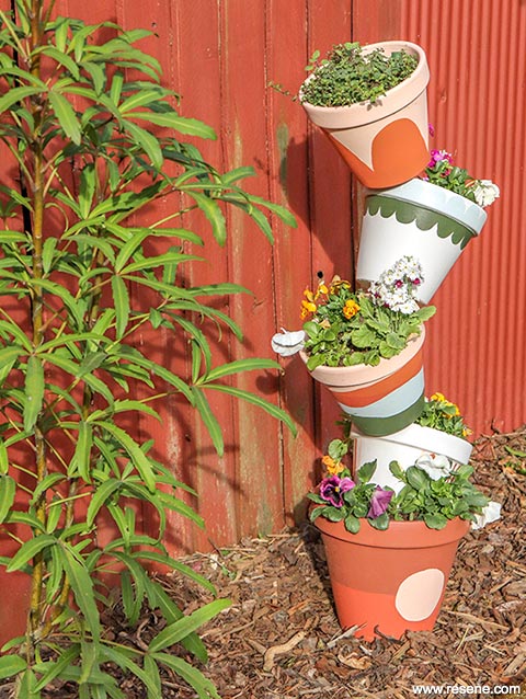 Build a topsy turvy planter from painted terracotta pots