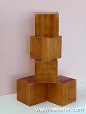 Create a cubist wooden sculpture