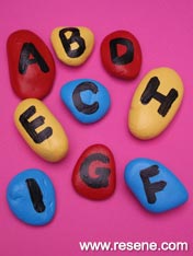 Paint rocks with the alphabet