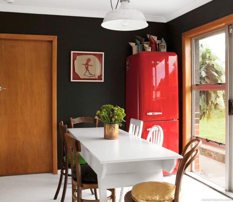 Black wall and red fridge