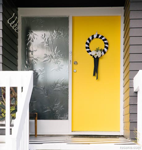 A bright yellow front door in Resene Spotlight