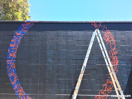 Painting the Tahuna Community Tennis Courts mural 2