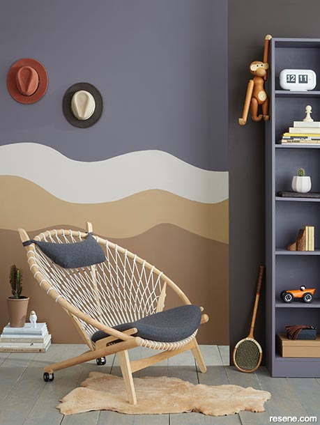 A grey room with a brown wall mural