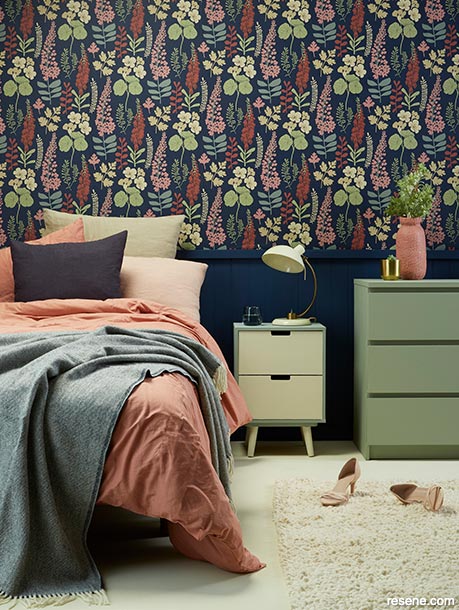 A bedroom with floral wallpaper