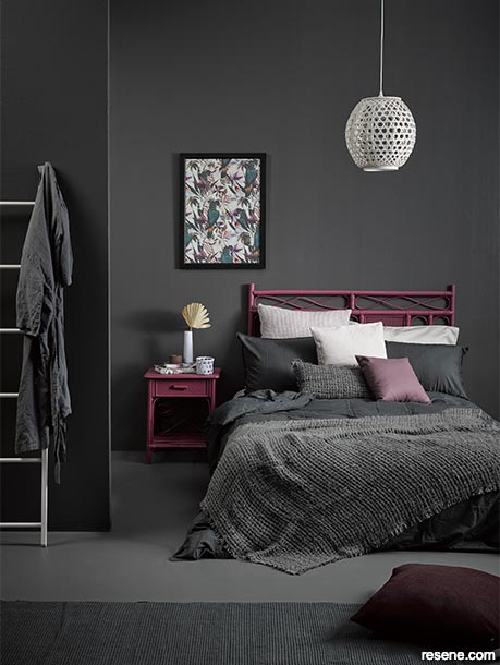 A moody grey bedroom with pink/red accents