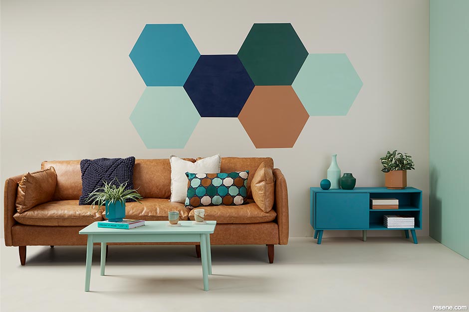 A lounge with contrasting colours and a hexagon wall pattern 