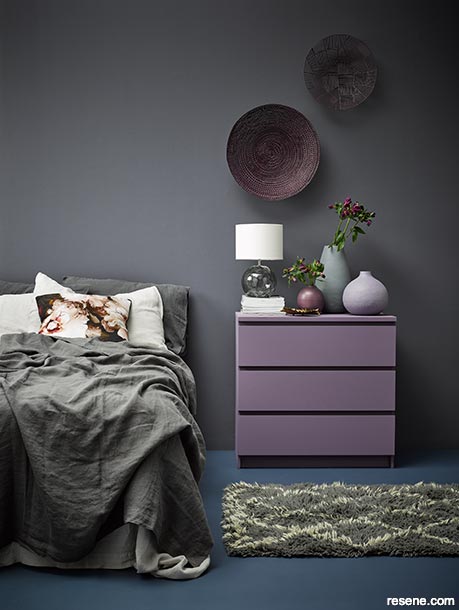 A charcoal bedroom with muted amethyst and deep teal shades