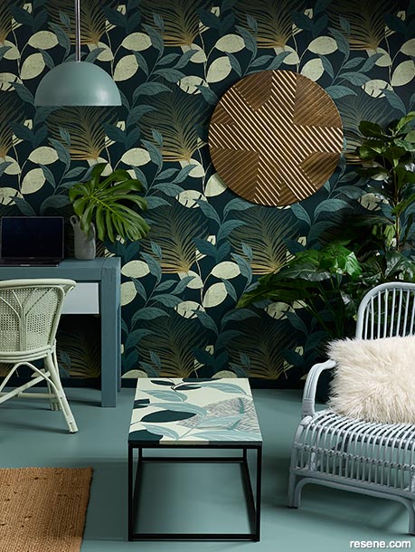 A green home office with tropical wallpaper