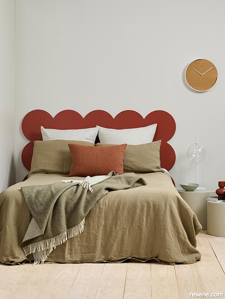 A bedroom with a red circular headboard