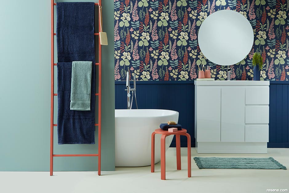 A bathroom with bold and colourful wallpaper