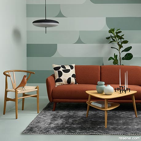 A green lounge with a geometric wall design