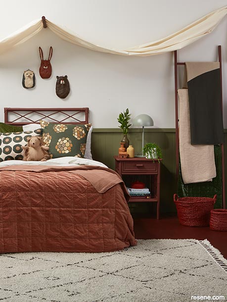 A tween bedroom painted in olive green and reddy brown