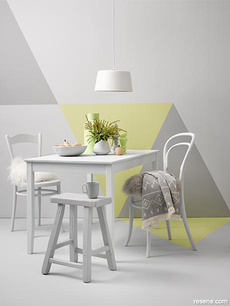 The darker tones against the contrasting yellow make this dining nook appear larger