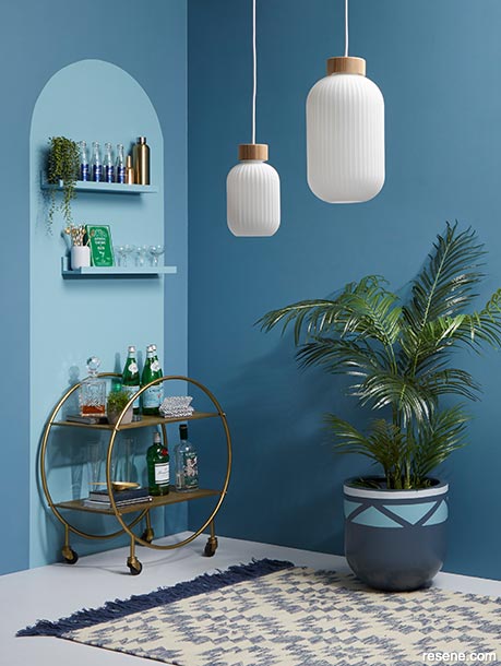 A blue interior with a simple contrasting shape on the wall for flair