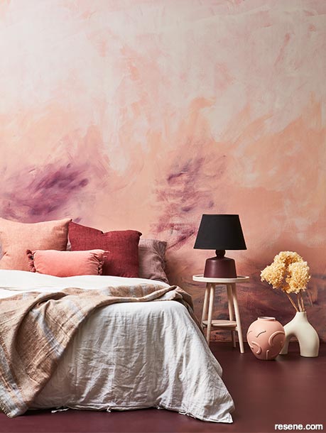 A bedroom with wine red floors and ethereal walls
