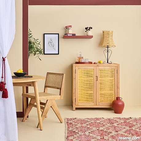 A dining area with a warm beige palette and pops of raspberry red