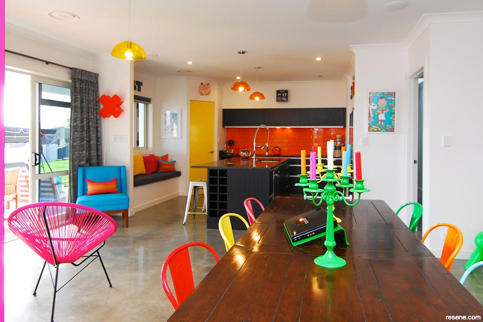 A kitchen and dining room with a 1960's inspired colour palette