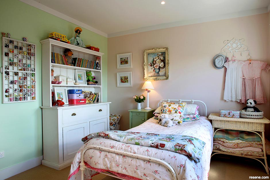 A light green and pink bedroom