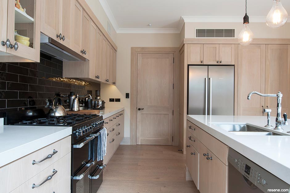 A warm white kitchen with oak cabinetry