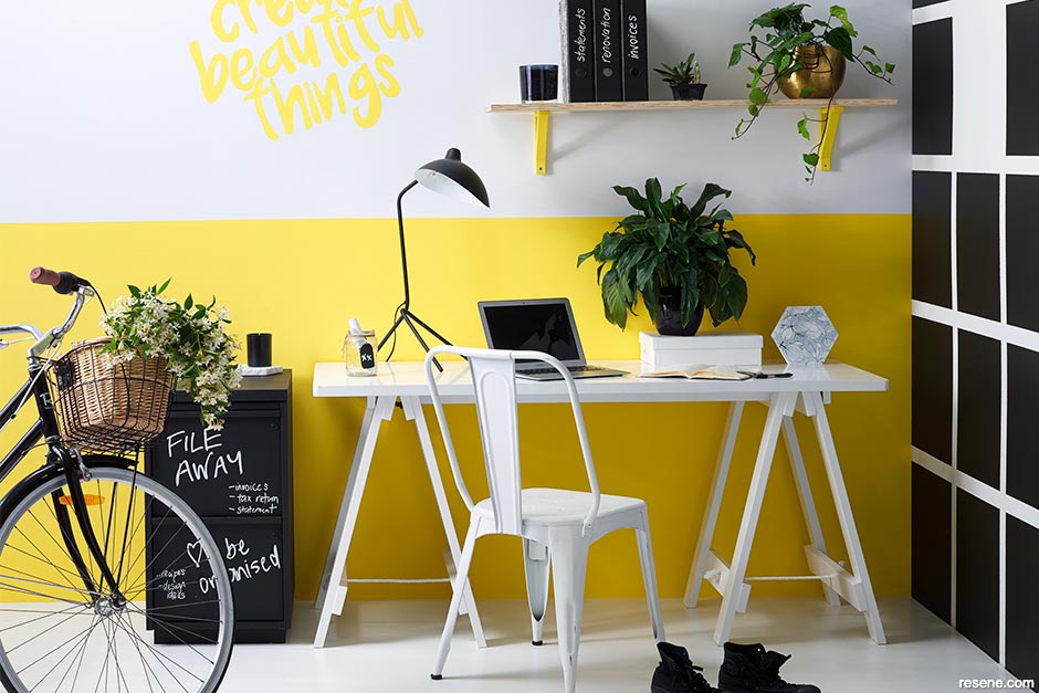 A home office painted with sunshine yellow and black