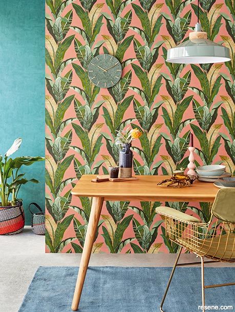 Dining room with palm leave print wallpaper