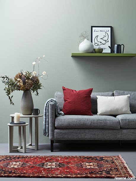 A soft grey-green interior with pops of red