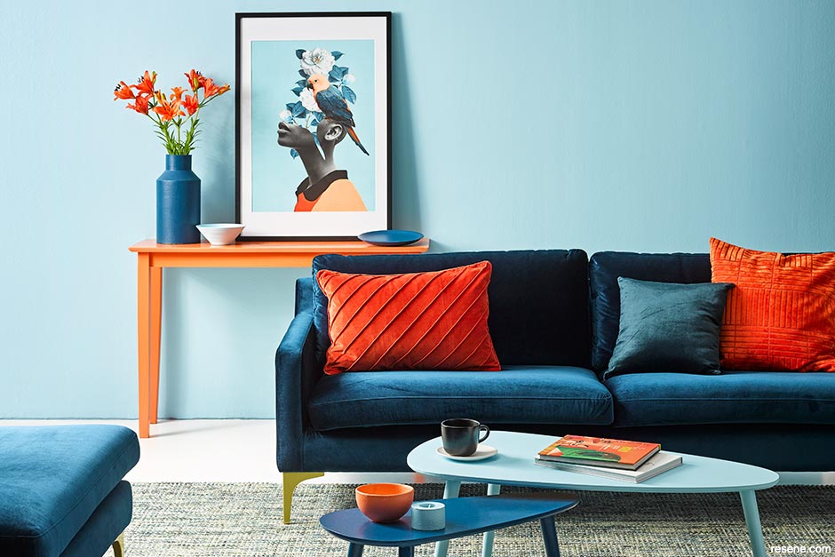 A lounge with a navy, orange, and white colour scheme