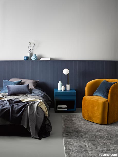 A bedroom painted in dark and moody blues