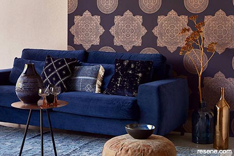 A statement wall with classic blue sofa