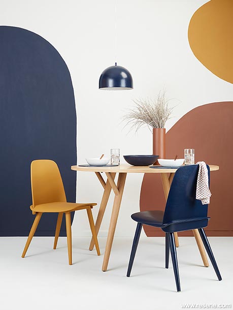 A curved wall mural feature in this warm dining room