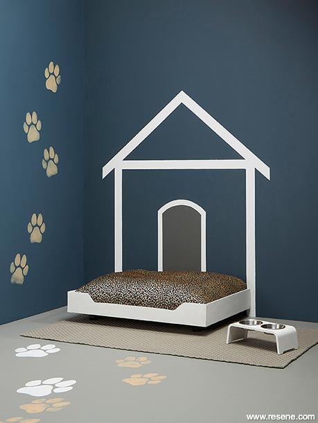 An indoor painted kennel outline with paw print features