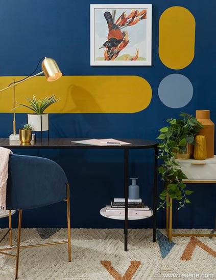 A dark blue office with a graphic painted wall feature