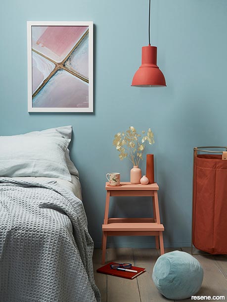 A terracotta pendant light in blue bedroom