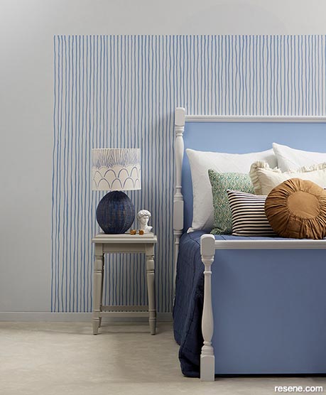 A bedroom with blue pinstripes