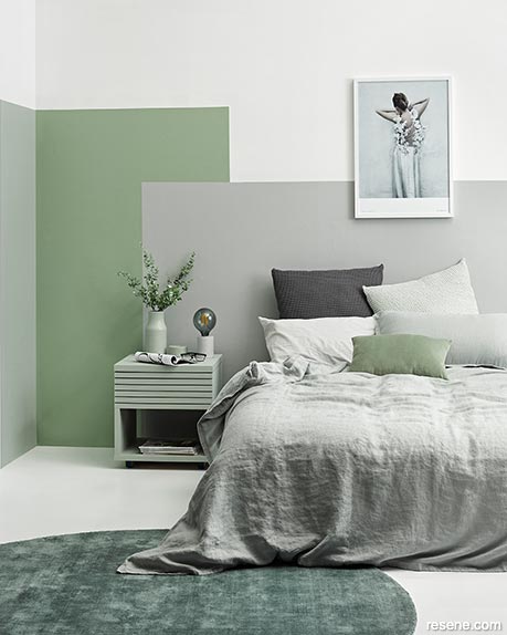 A green and grey colour blocked bedroom