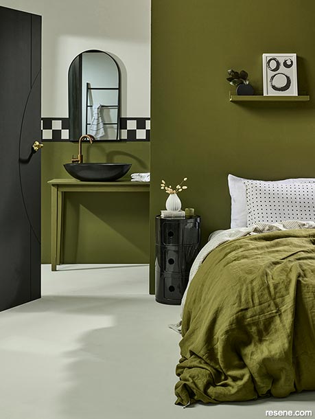 A dark green bedroom and ensuite