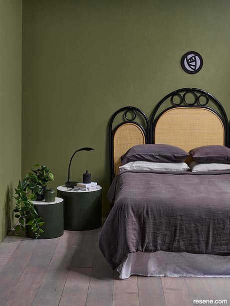 A dark green Art Nouveau-inspired bedroom
