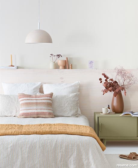 A relaxing bedroom with a stained wooden headboard