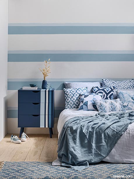 A bedroom with blue and white stripes
