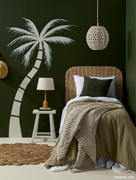 A bedroom with a bold palm tree mural