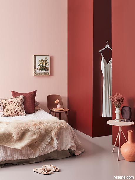 A bedroom with contrasting light and dark reds