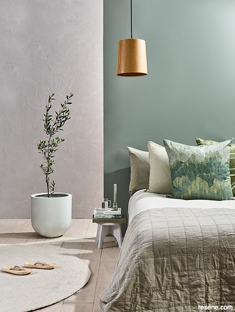 A green and grey bedroom with an irregular brush pattern
