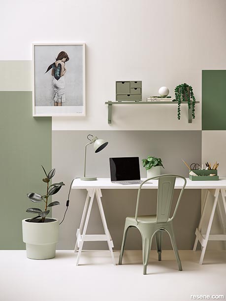 A home office painted in natural greens