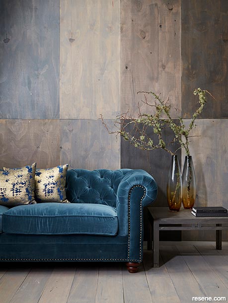 A lounge wall stained with multiple hues of brown and grey