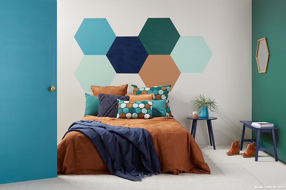 A colourful bedroom with painted geometric shapes