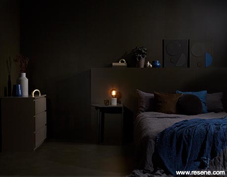 A chocolate brown bedroom with blue accessories